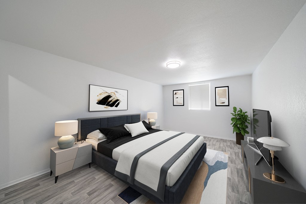 A bedroom with a large bed and a painting above it. at Red Bay Apartment Complex, Jacksonville, FL, 32211