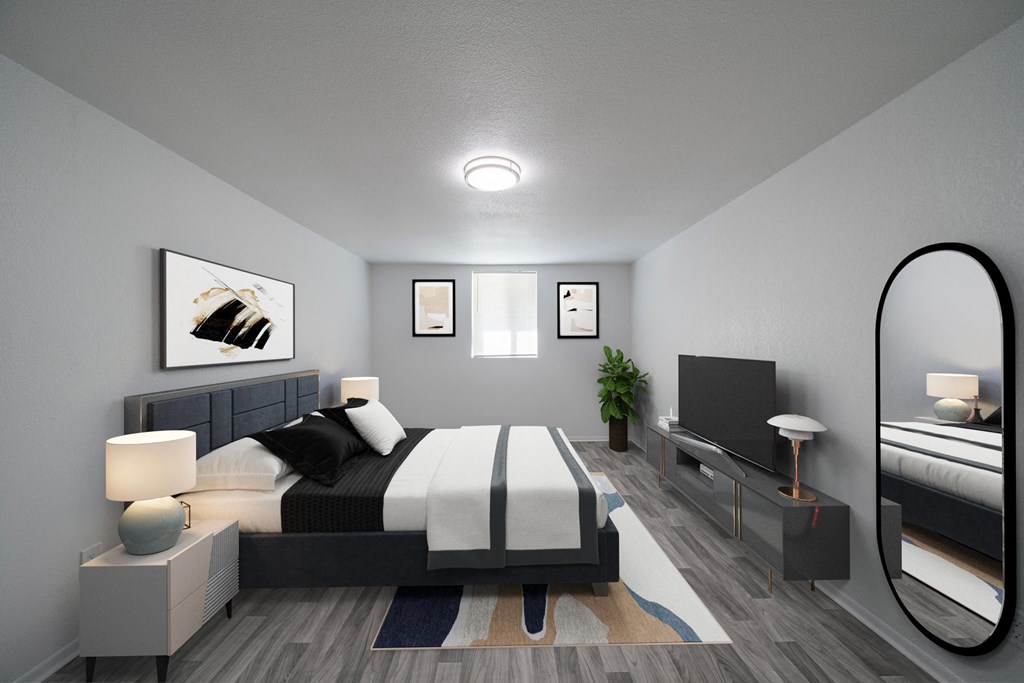 A modern bedroom with a large bed and a flat screen TV. at Red Bay Apartment Complex, Jacksonville, FL, 32211