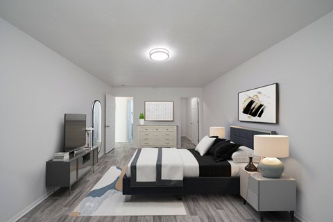 A modern bedroom with a large bed and a television. at Red Bay Apartment Complex, Jacksonville, FL, 32211