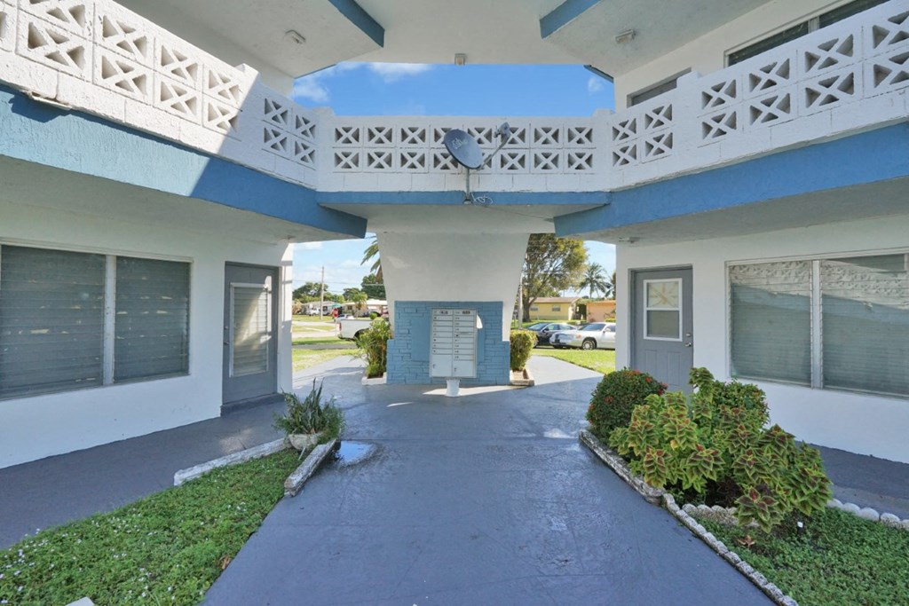 a white and blue building with a blue sky in the background