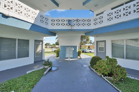 a white and blue building with a blue sky in the background