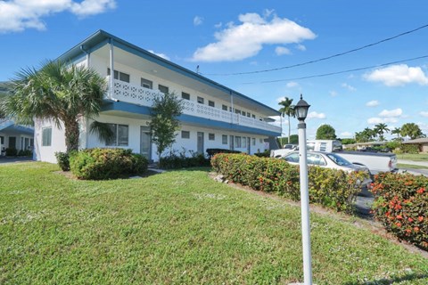 a large white building with a street light in front of it