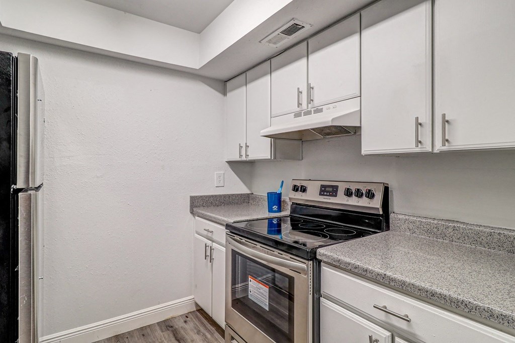 a kitchen with white cabinets and stainless steel appliances at Red Bay Apartment Complex, Florida, 32211