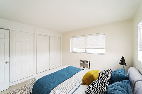 a bedroom with a bed and two closets