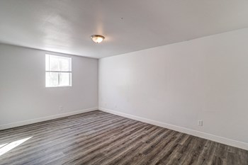 a bedroom with white walls and a window - Photo Gallery 24