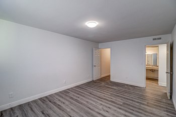 a bedroom with hardwood floors and grey walls - Photo Gallery 20