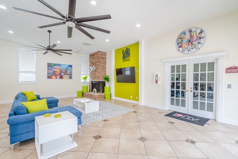 A living room with a blue couch and a white coffee table.