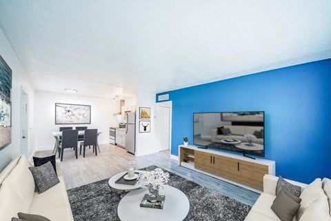 a living room with a blue wall and a television