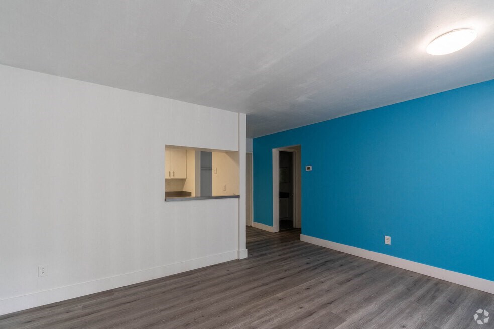 a bedroom with a blue wall and white walls