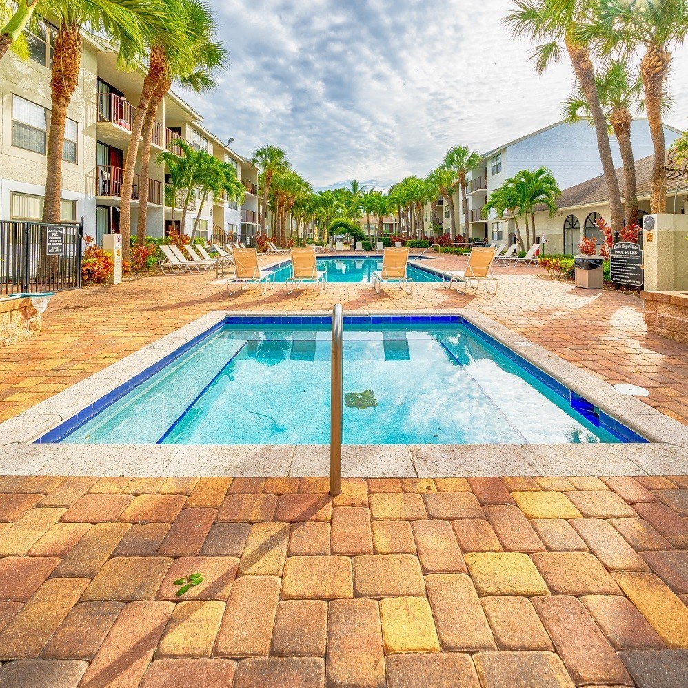 a swimming pool is next to a resort style pool
