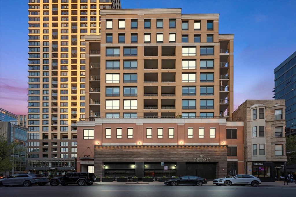 a tall building on a city street with cars at Chateau on Wells, Illinois, 60654