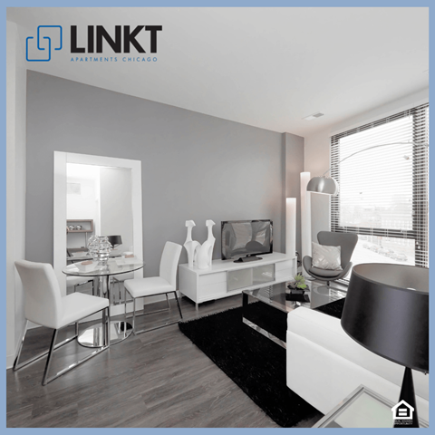 a living room with white furniture and a black rug