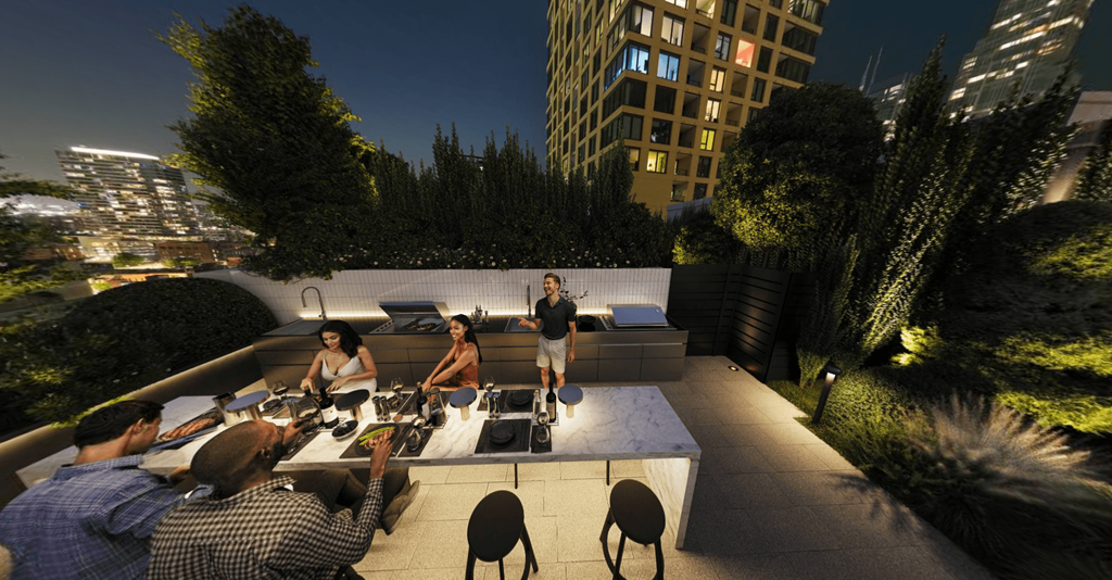 a group of people sitting around a table on a rooftop terrace at night at Chateau on Wells, Chicago