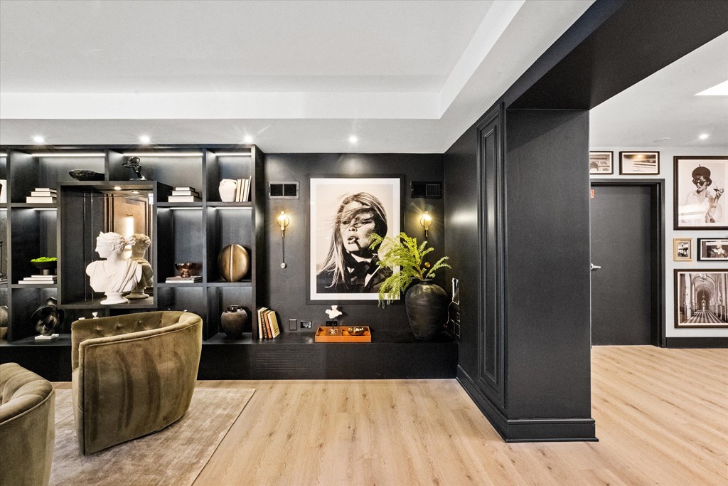 A modern living room with a brown leather chair and a wooden floor at Chateau on Wells, Chicago, IL