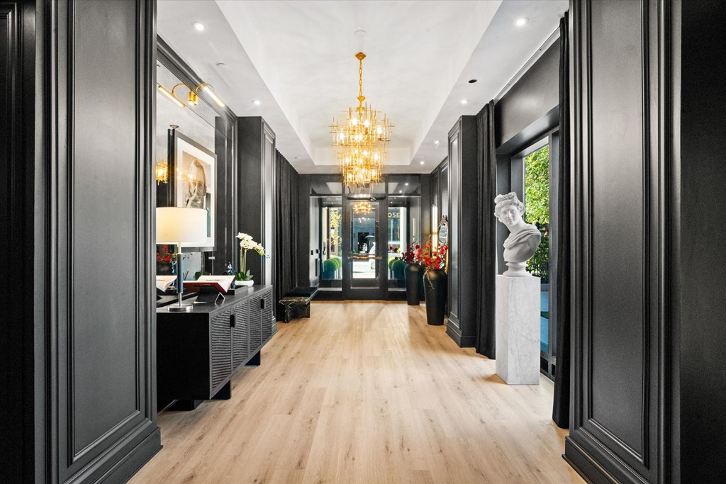 A long hallway with a chandelier hanging from the ceiling at Chateau on Wells, Illinois, 60654