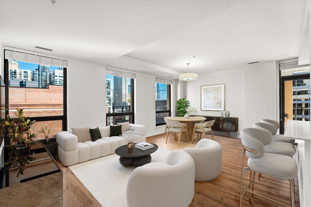 A modern living room with white furniture and a large window overlooking the city at Chateau on Wells, Illinois