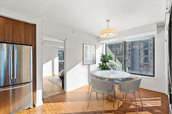 A modern dining room with a glass table and chairs at Chateau on Wells, Chicago, IL