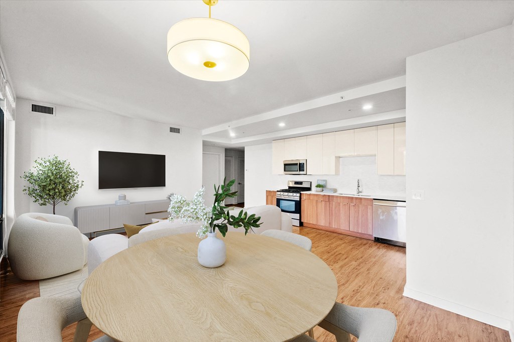 A modern dining room with a wooden table and chairs at Chateau on Wells, Chicago, 60654