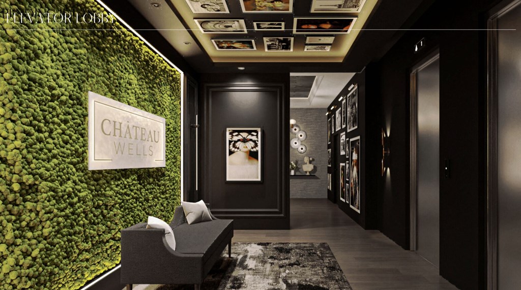 a living wall with green plants and a chair in a lobby at Chateau on Wells, Chicago, 60654