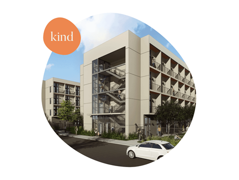 A white car is parked in front of a building.