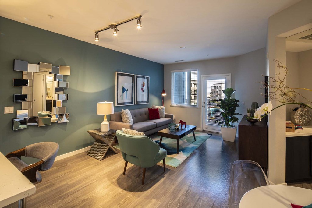 a living room with a couch and chairs in front of a window