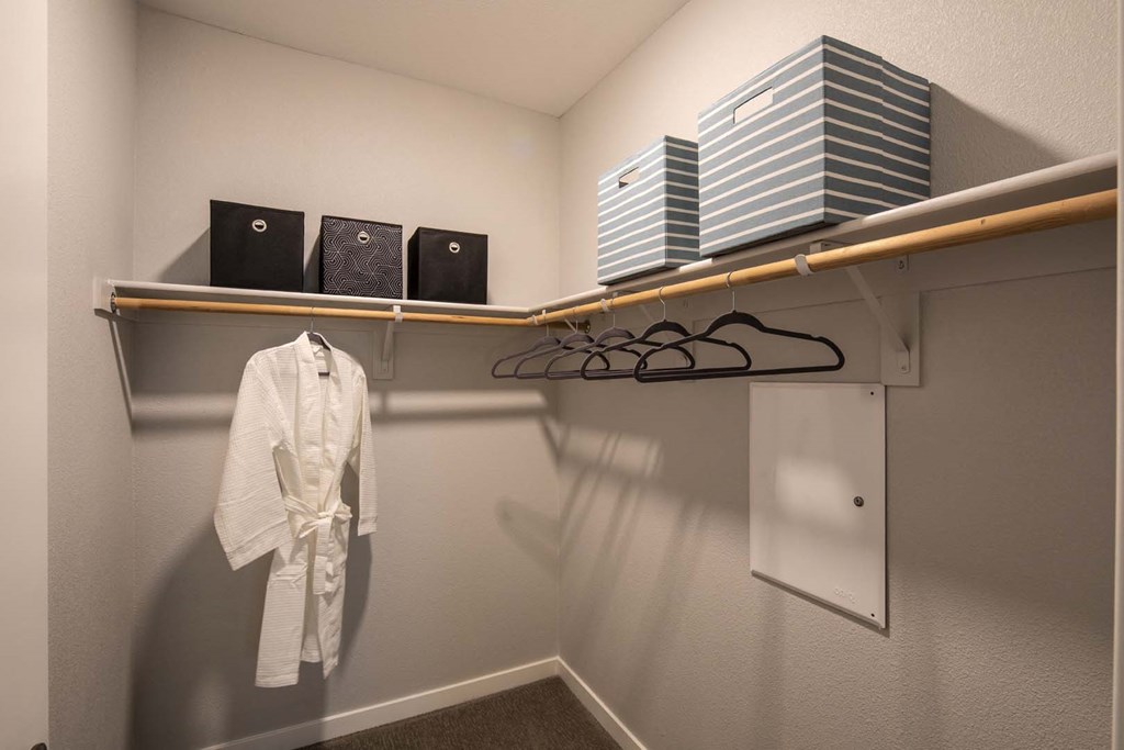 a walk in closet in a bedroom plus den unit.