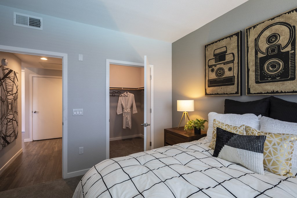 a bedroom with a bed and a nightstand with a lamp