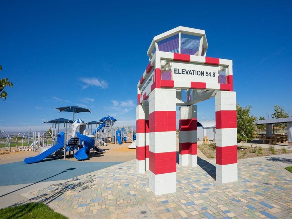 a lifeguard tower with a playground in the background