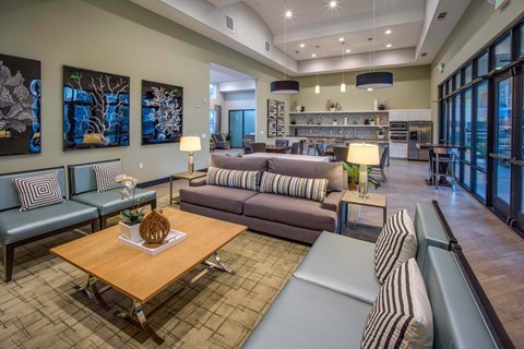 A living room with a wooden coffee table and striped couches.
