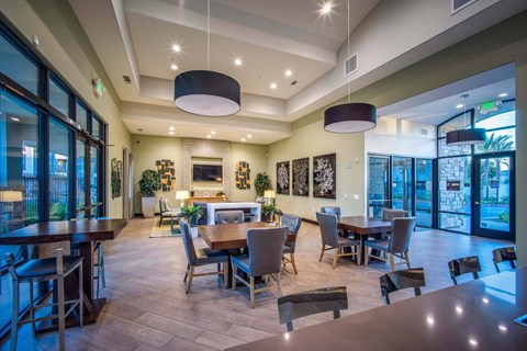 A modern dining room with a large table and chairs.