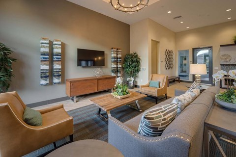 A living room with a grey couch and a wooden coffee table.
