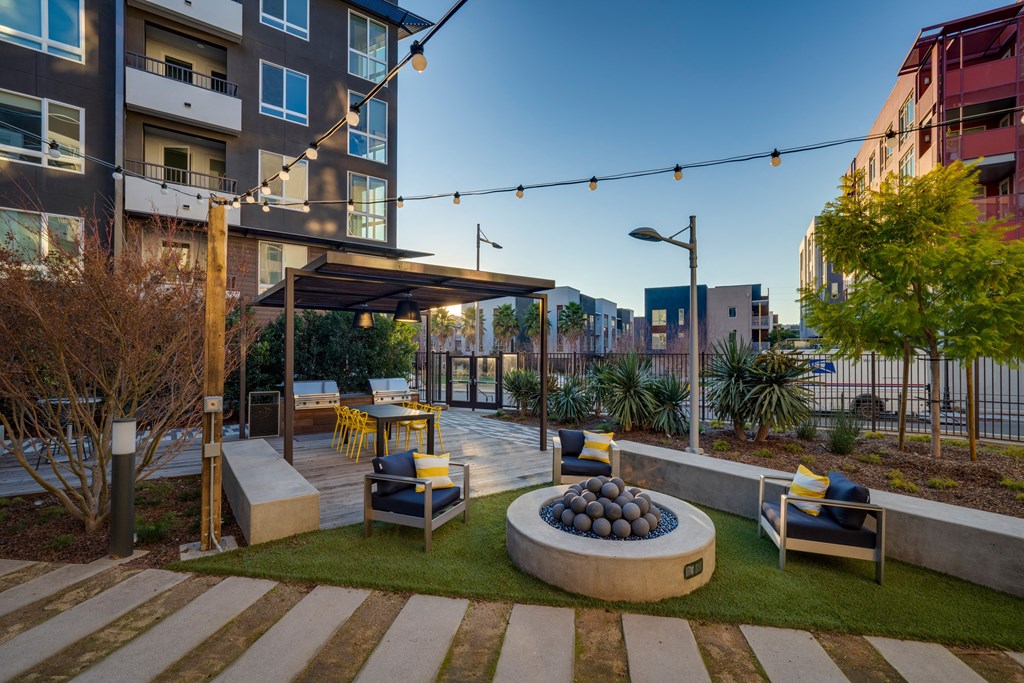 a courtyard with a fire pit and seating