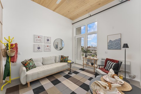 A living room with a white couch and a checkered floor.