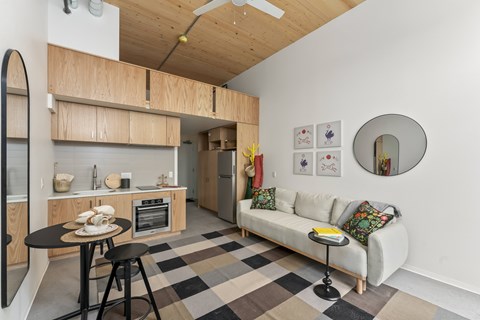 A kitchen with a table and a couch.