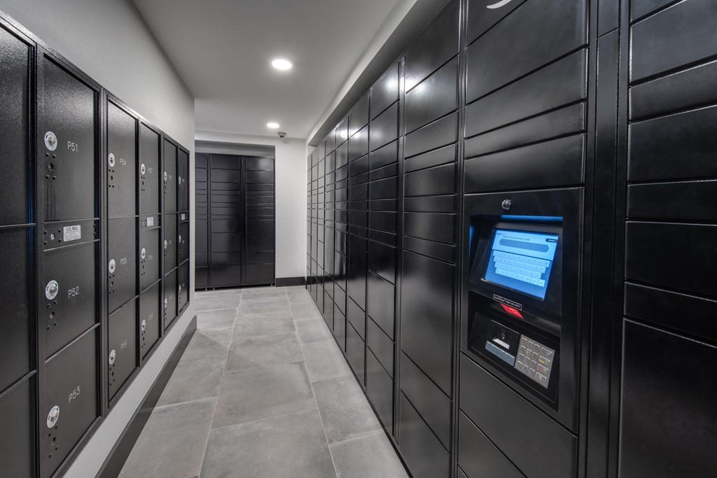 a row of black lockers with a screen in the middle