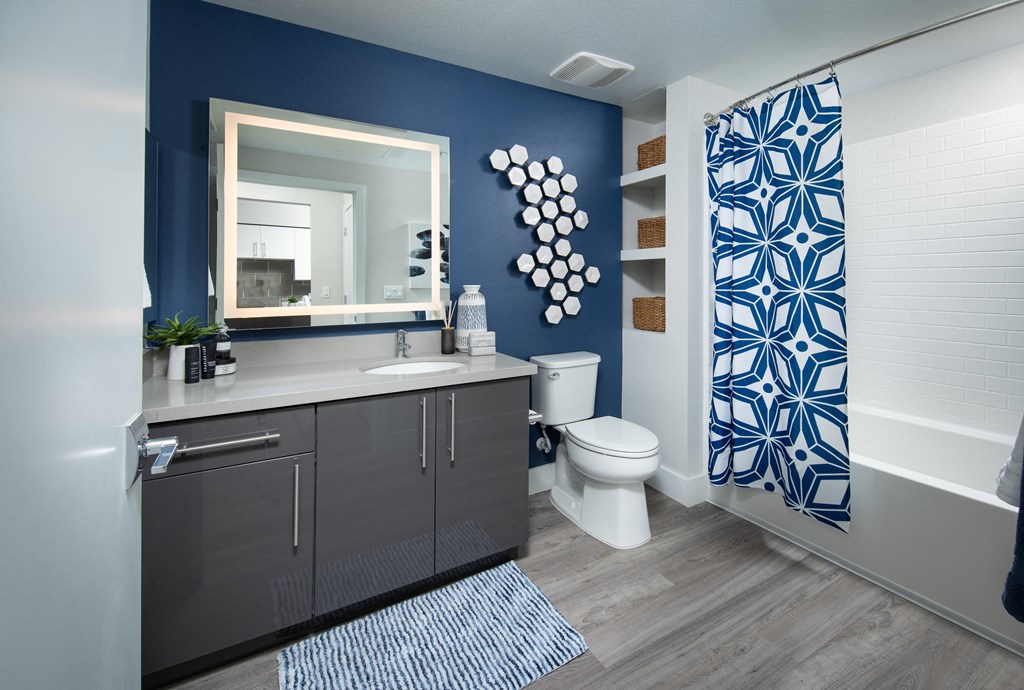 a bathroom with a blue and white shower curtain