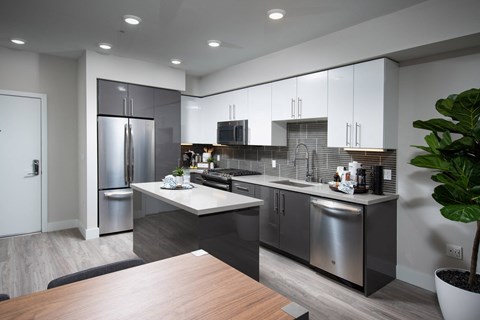 a kitchen with stainless steel appliances and a table