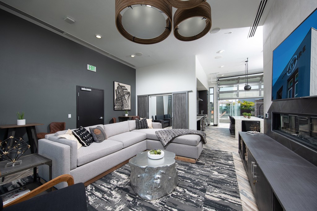 a living room filled with furniture and a large window