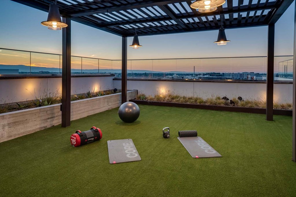 a rooftop gym with a view of the hudson river