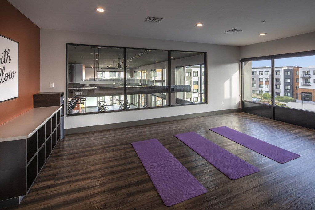 a yoga studio with purple mats on the floor