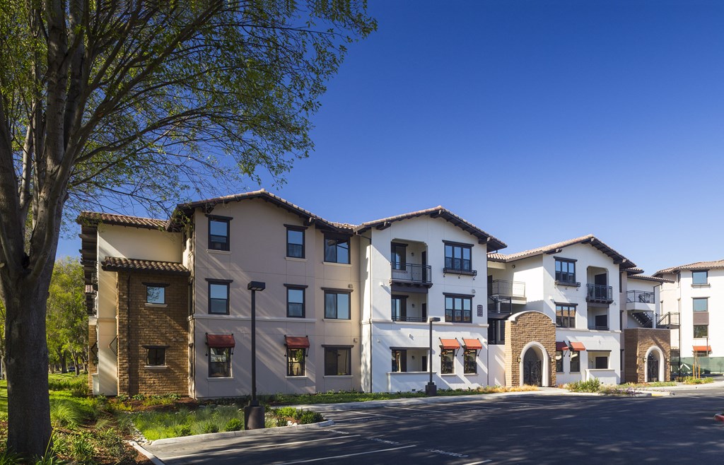 a picture of a street with apartment buildings in the background