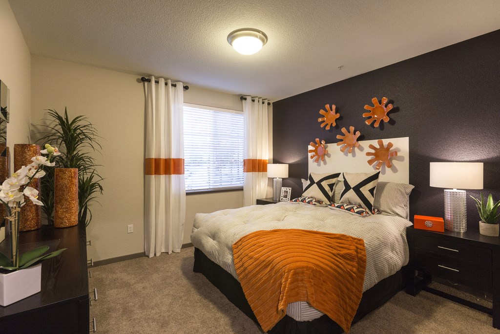 a bedroom with a large bed in front of a window