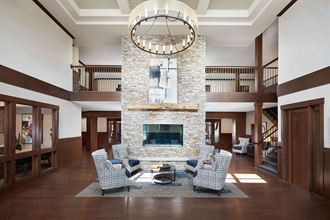 a large living room with a stone fireplace