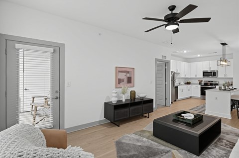 A modern living room with a brown coffee table and a ceiling fan.