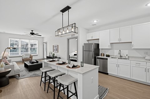 A modern kitchen with white cabinets and a large island.