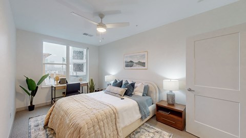 Bedroom with ceiling fan and large windows at Current812 Apartments, Clarksville, IN 47129