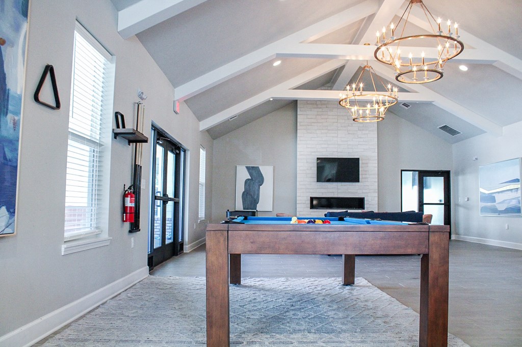 a game room with a pool table and a fireplace