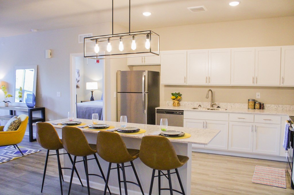 a kitchen with white cabinets and a table with chairs at Sage Springs, Elizabethtown, KY