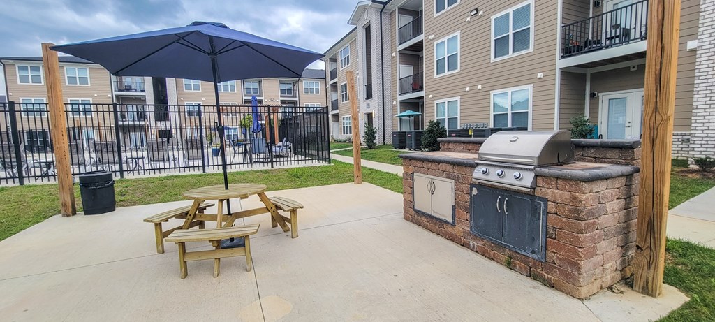 our apartments have an outdoor patio with a grill and picnic table at Arlington Farms, Greenwood