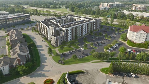 A large building with a parking lot in front of it.